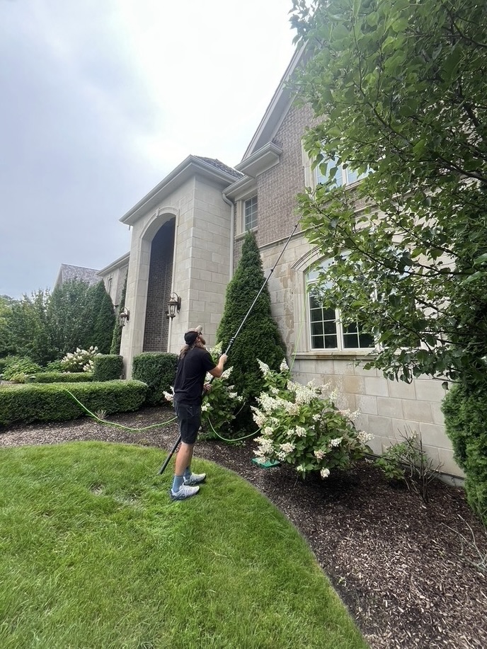 Summit Window Washing technician cleaning windows